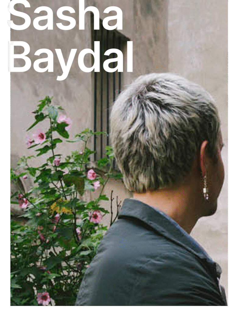 A persons head from behind. Sasha Baydal written in white letters.