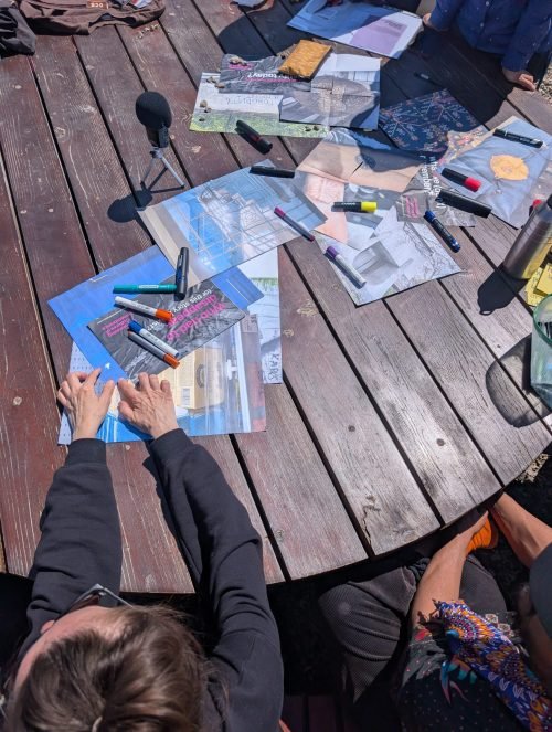 In the picture there is a table with colourful pictures lying on it.